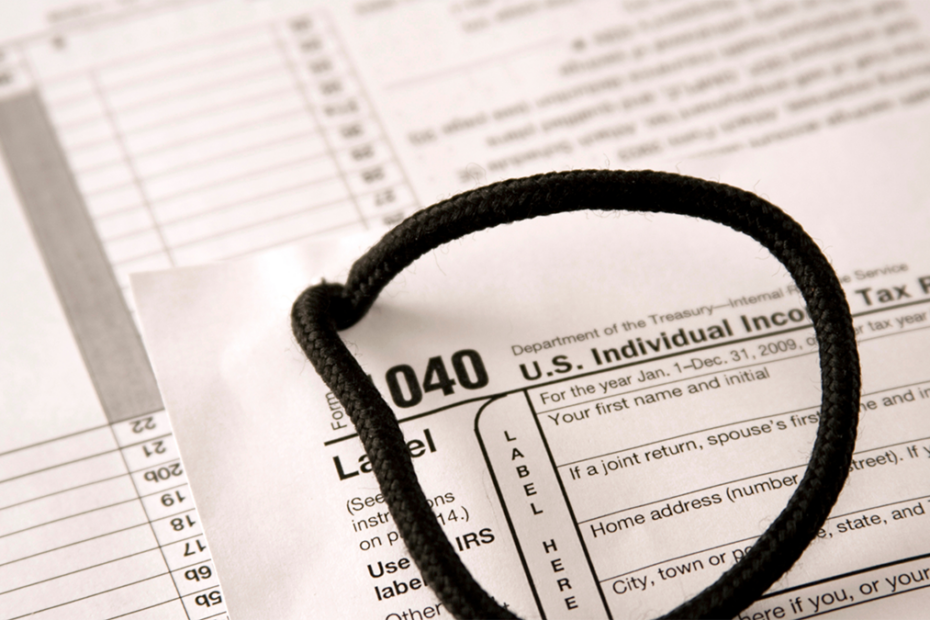 Close up on a 1040 Tax form with a cord looped on top of it